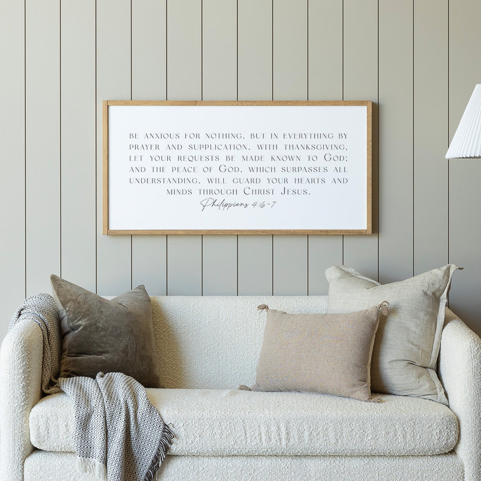 Scripture wall art with the verse Jesus Christ is the same yesterday and today and forever, framed in wood and styled above a rattan cabinet. Styled with greenery, this setup is perfect for adding faith-based inspiration to farmhouse or modern home decor.
