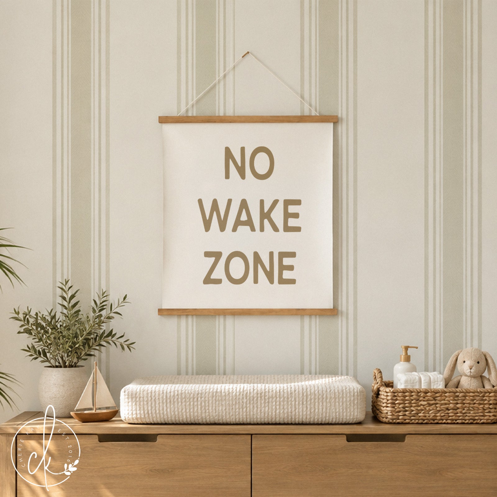 Coastal-themed nursery with NO WAKE ZONE canvas sign, surfboard decor, and natural wood crib, creating a serene beach-inspired baby room.