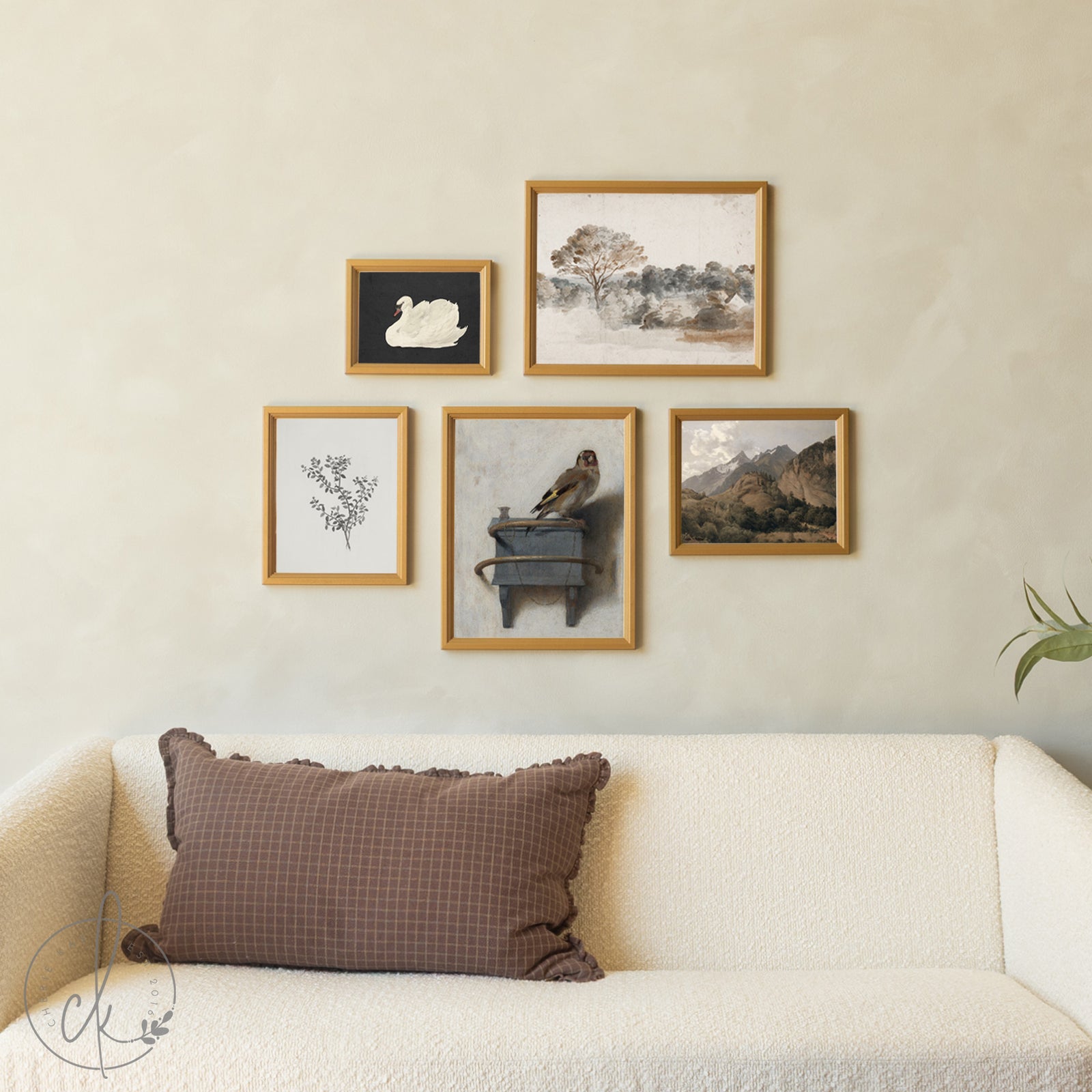 Wall with framed pictures above a sofa