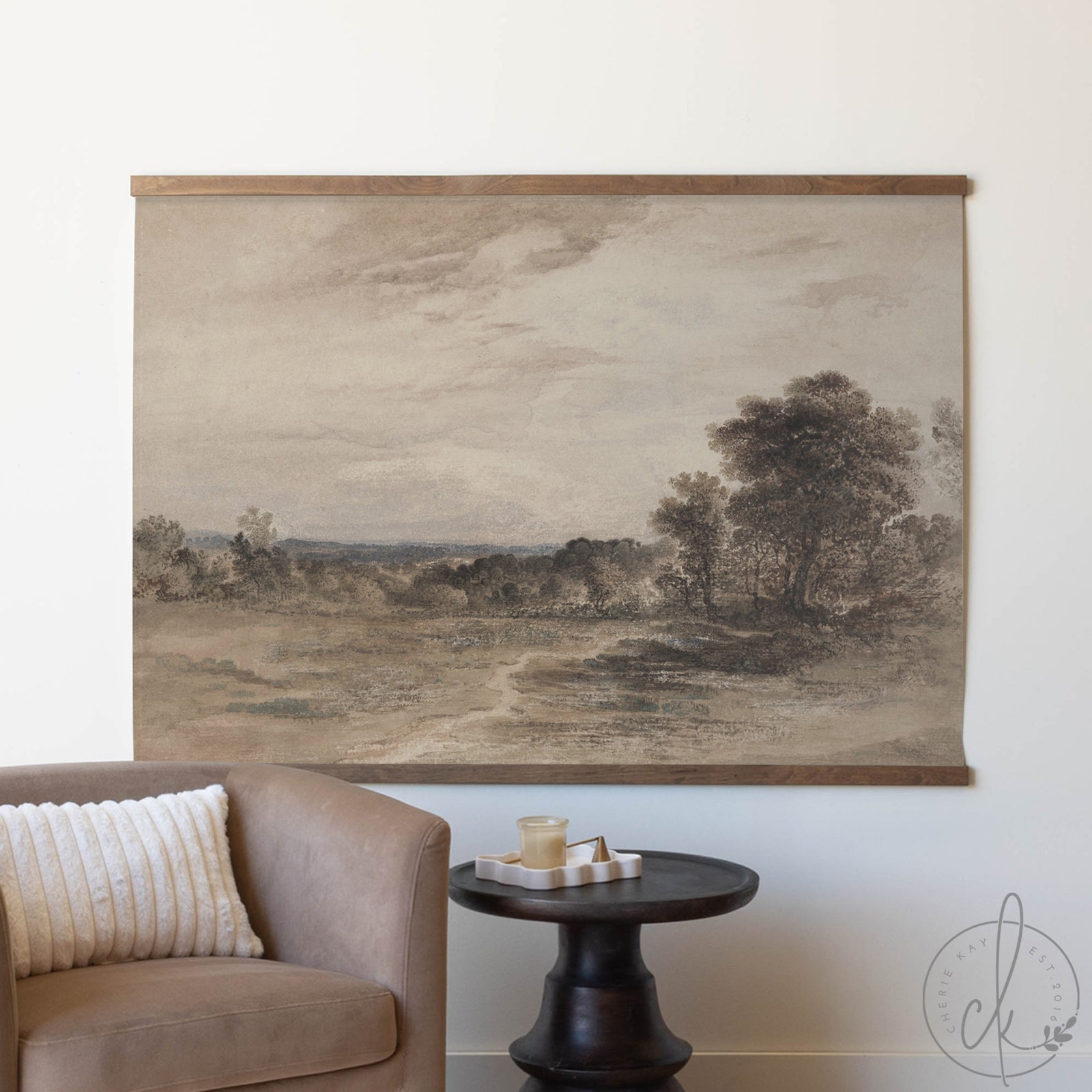 Landscape painting on a wall above a sofa and side table.