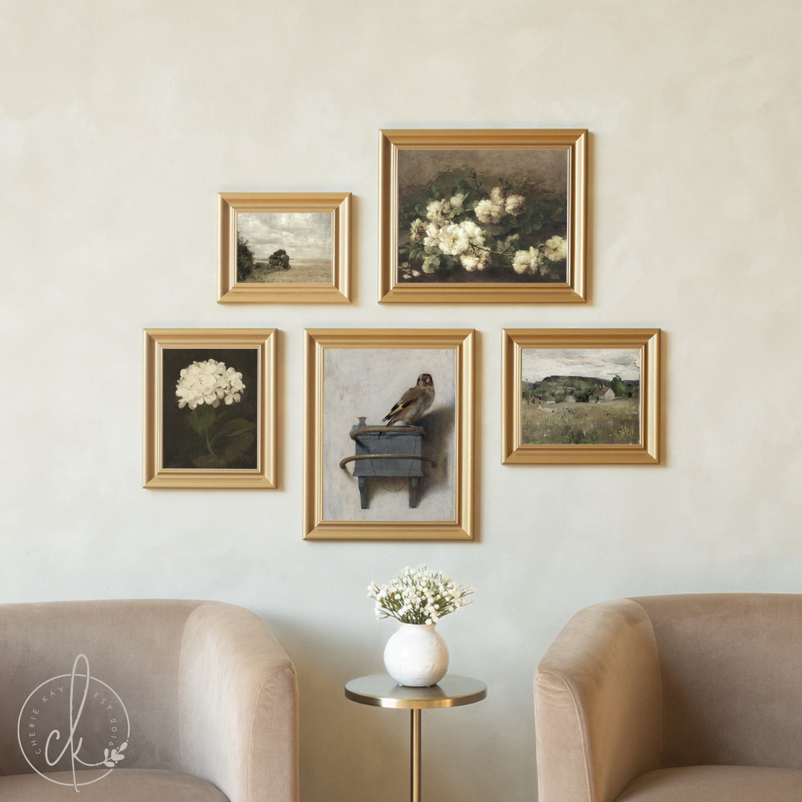 Wall with framed artworks and a vase with flowers on a small table.