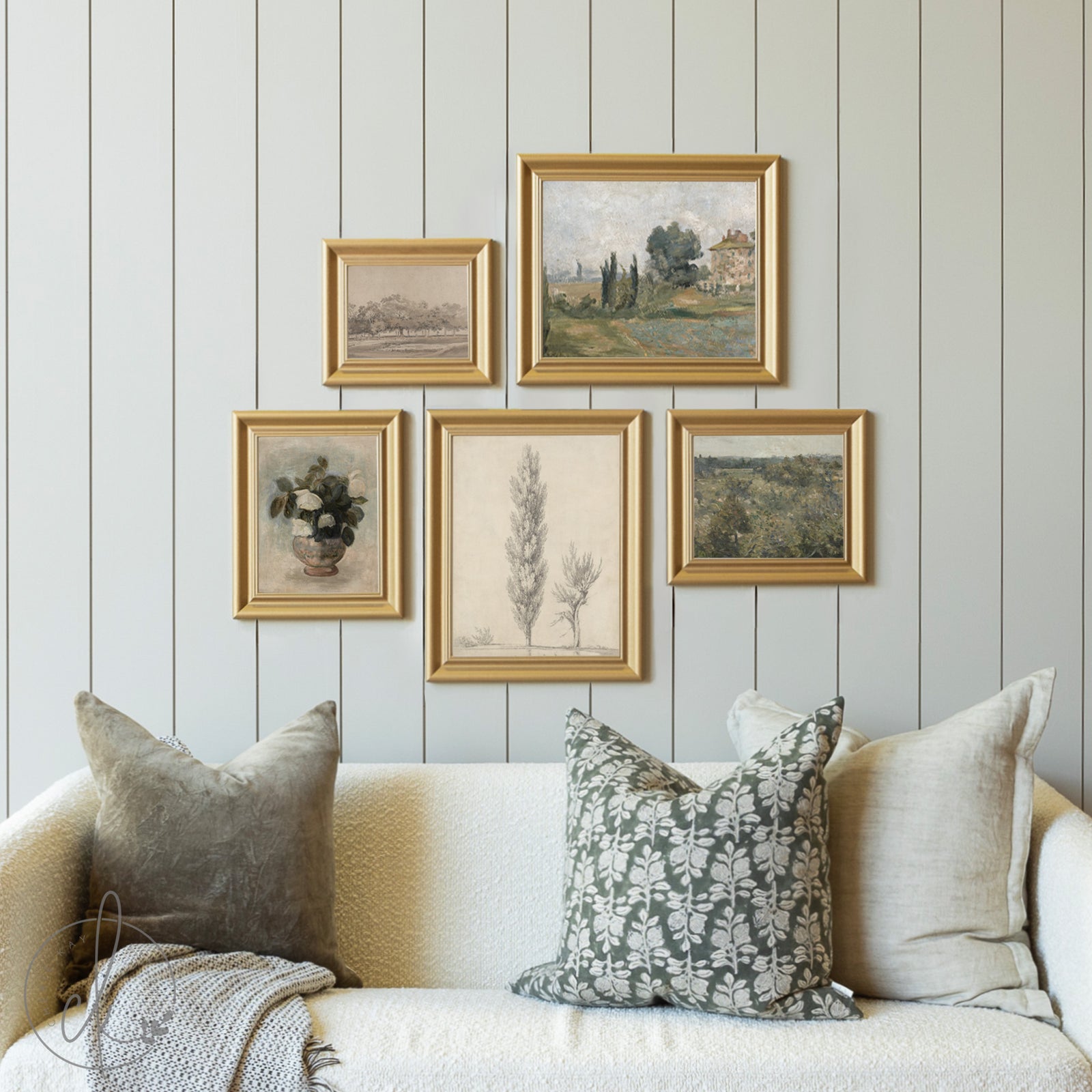 Framed artwork on a wall above a sofa with decorative pillows.