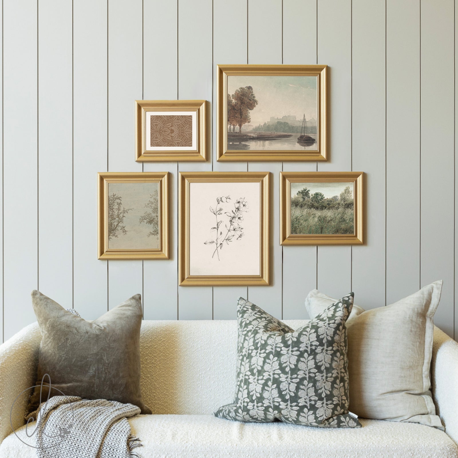 Decorative wall art with gold frames on a light wooden panel wall above a sofa.