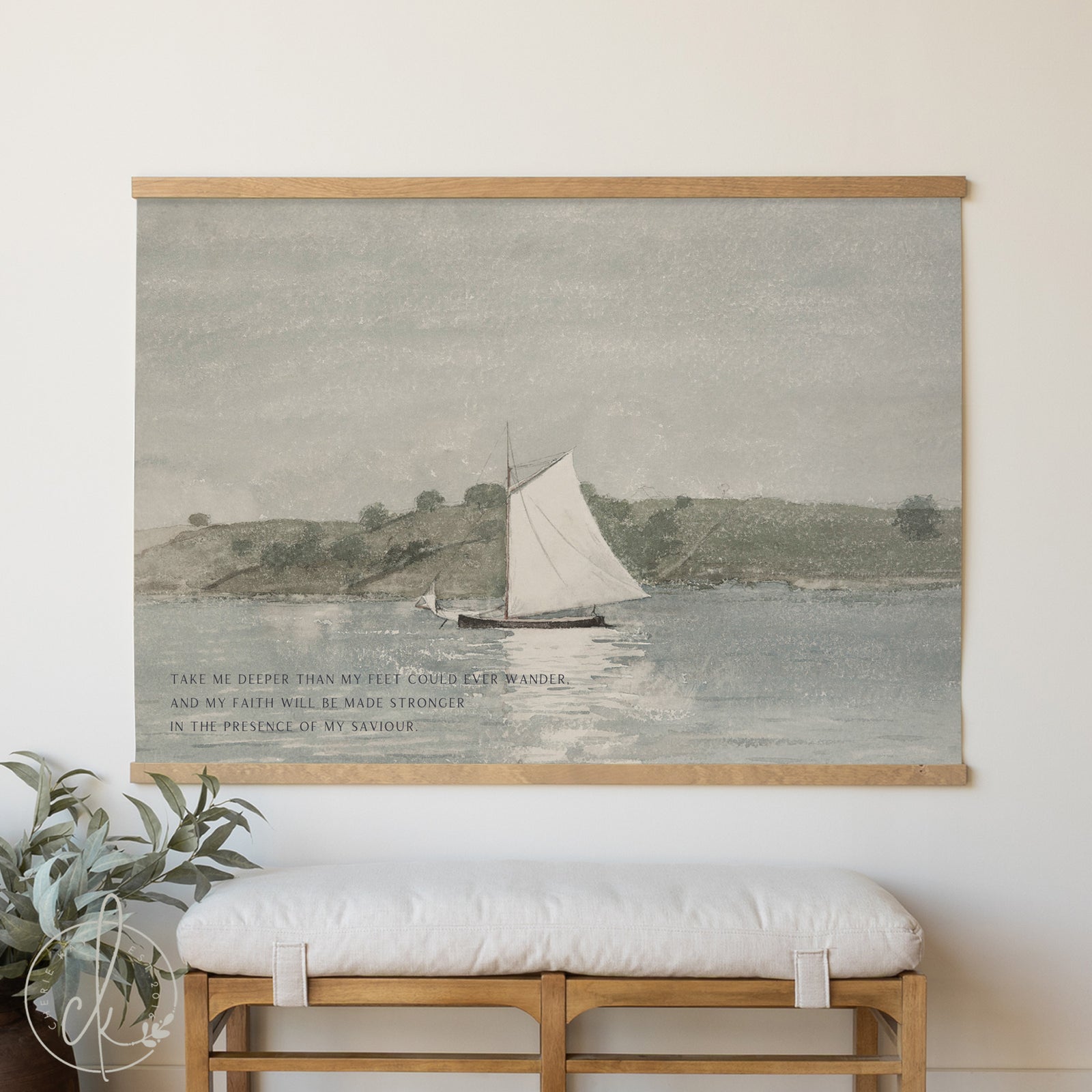 Framed artwork of a sailboat on water with a wooden bench and plant below.