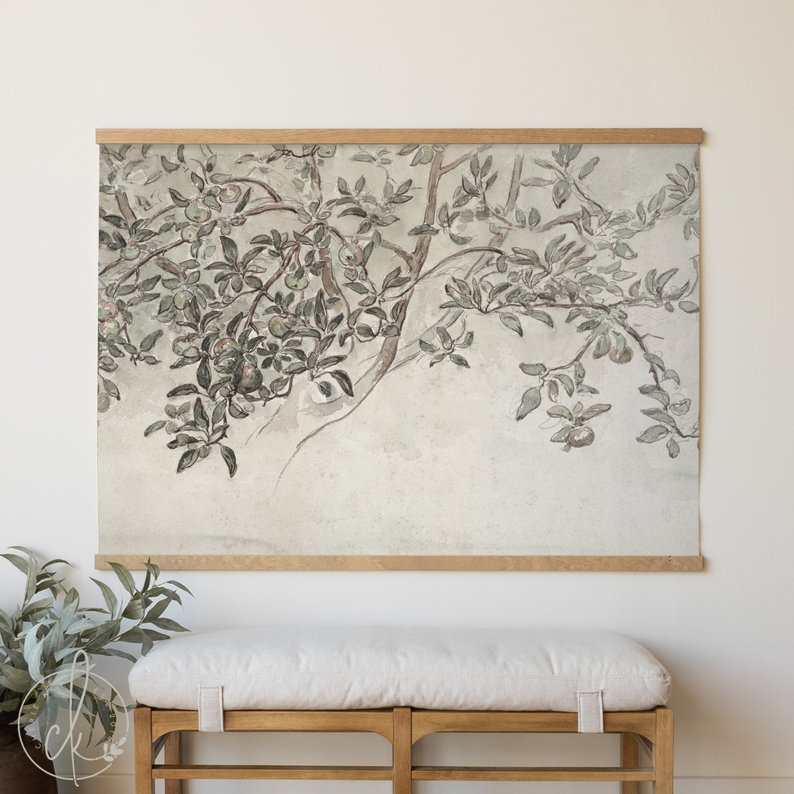 Framed botanical wall art above a wooden bench with a plant on a light background