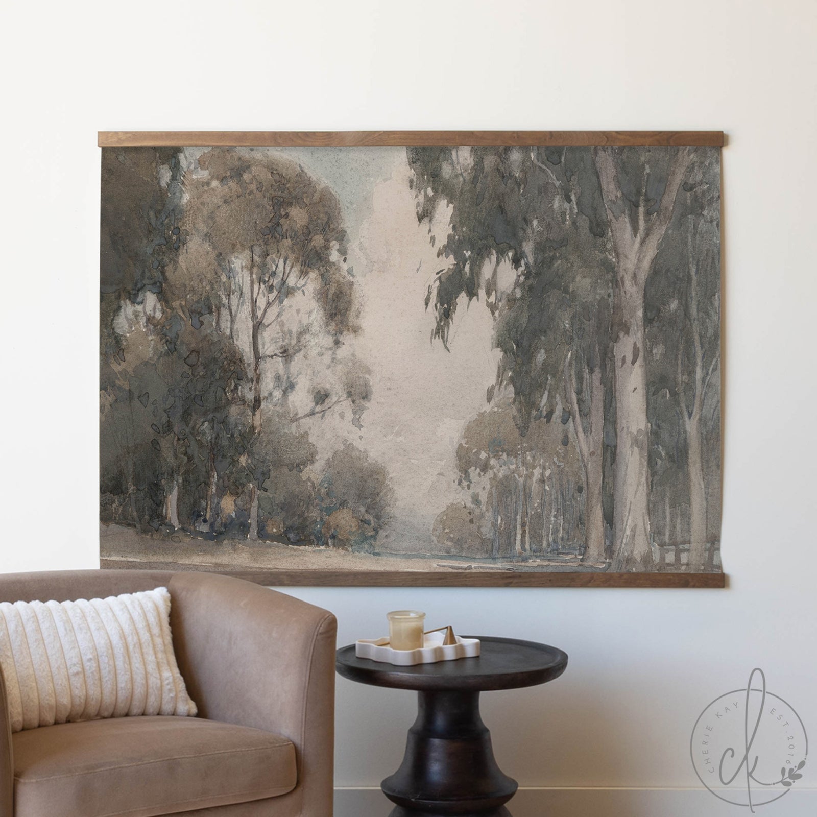 Large wall tapestry of trees in a forest scene hanging above a sofa in a living room.