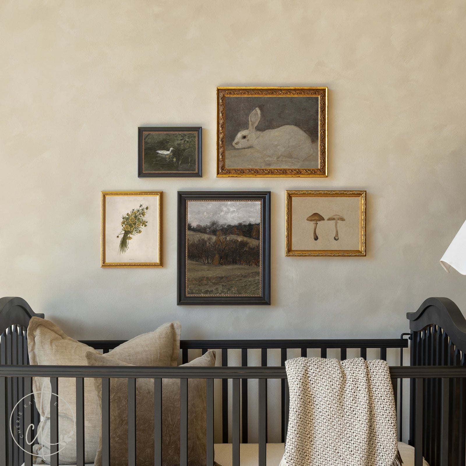 Nursery with black crib and framed artwork on the wall