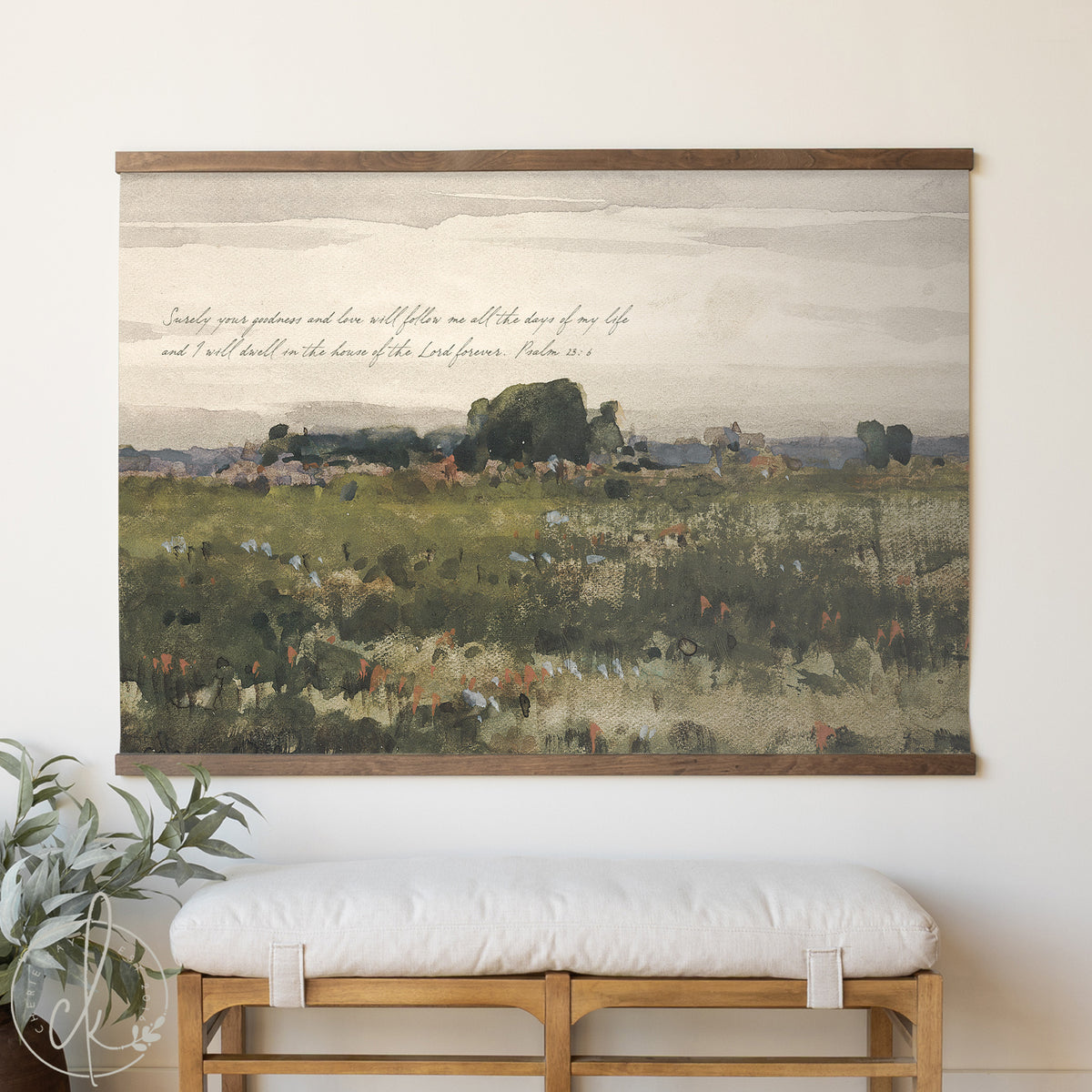 Framed landscape painting with text above a white cushioned bench.