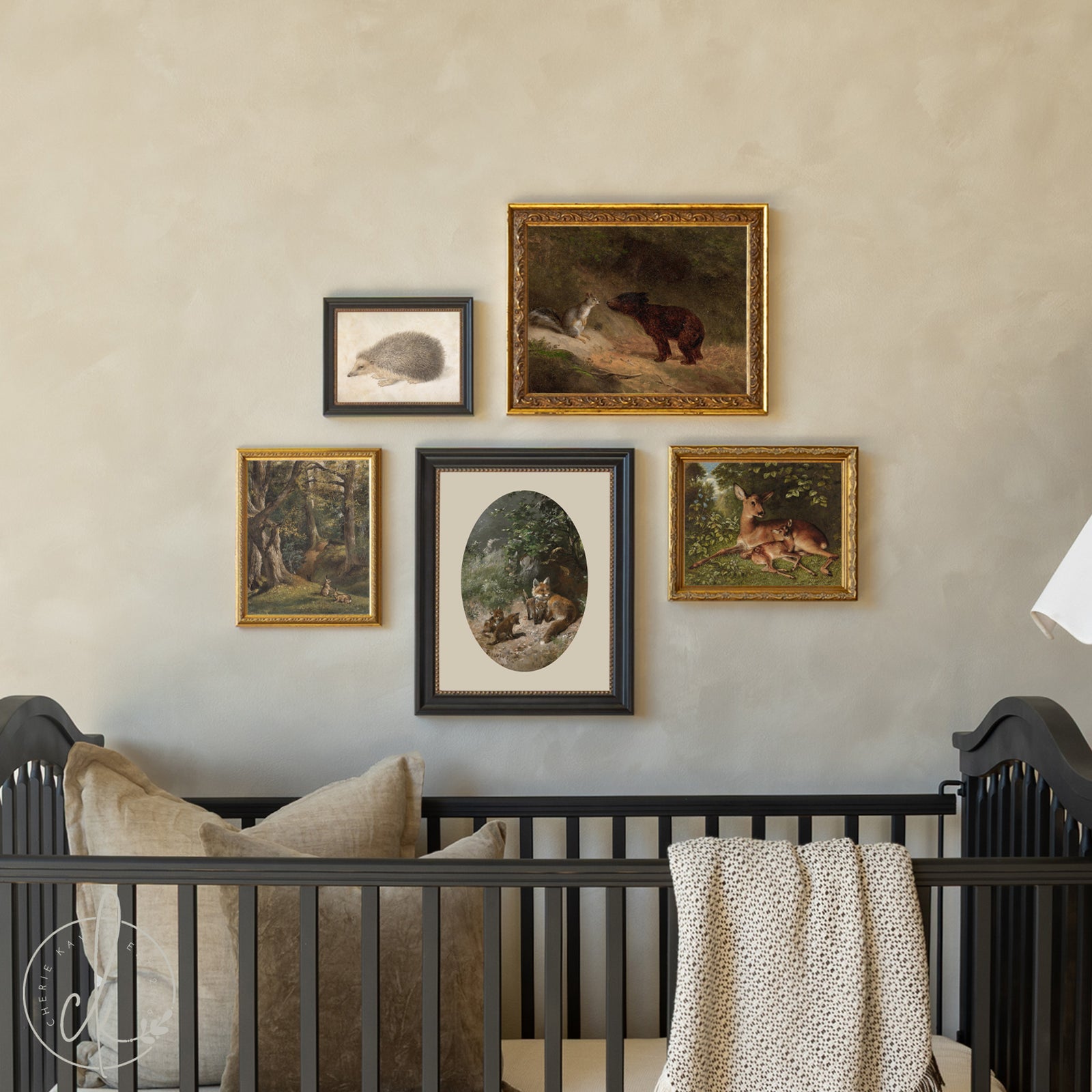 Nursery with black crib and framed animal artwork on the wall.