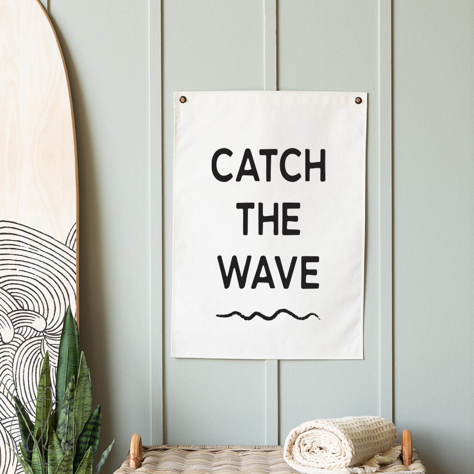 Decorative sign with 'Catch the Wave' text on a light blue wall.