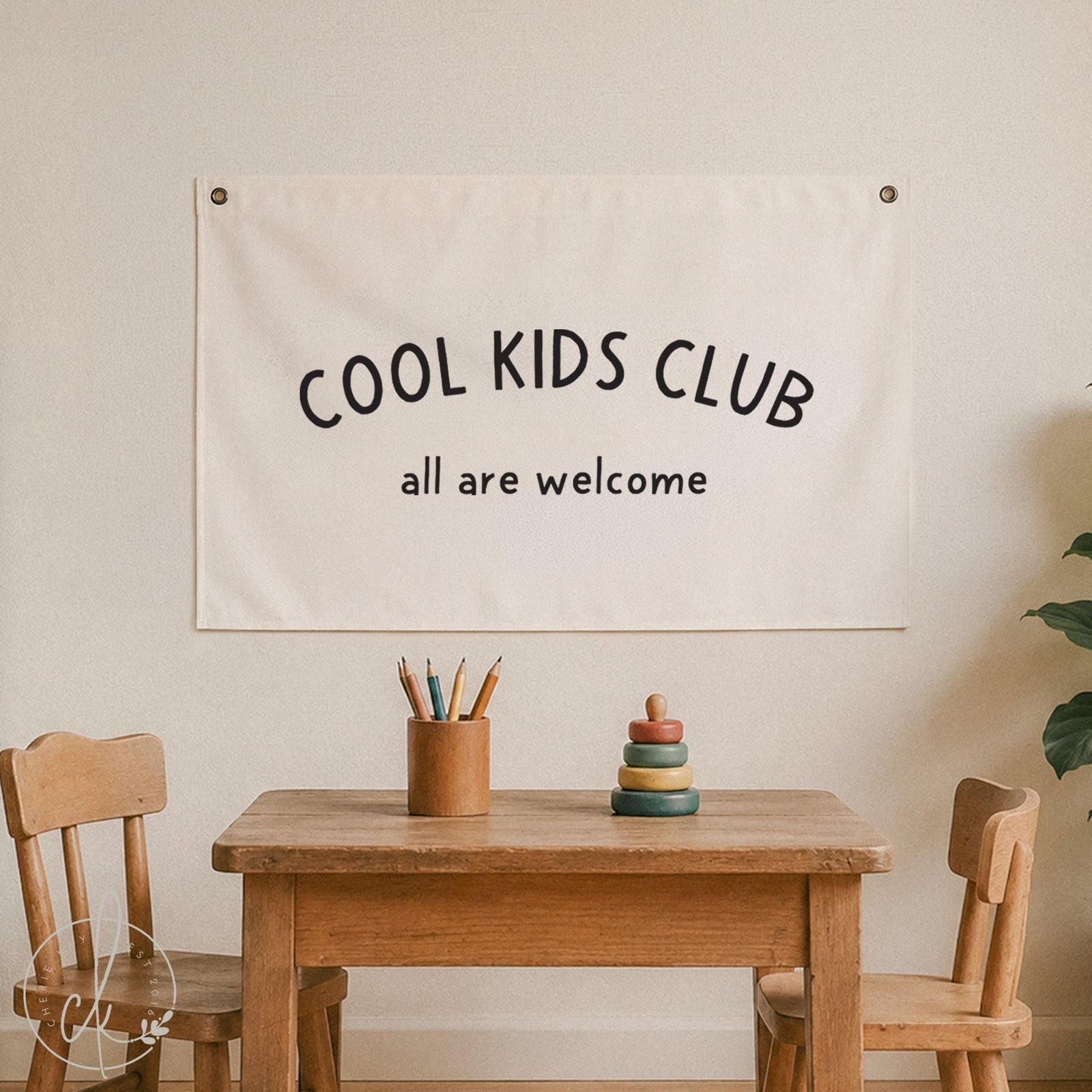 Cool Kids Club All Are Welcome canvas banner hanging in a cozy kids' playroom with wooden furniture and soft toys, perfect for neutral nursery decor, playroom wall art, or classroom decoration.