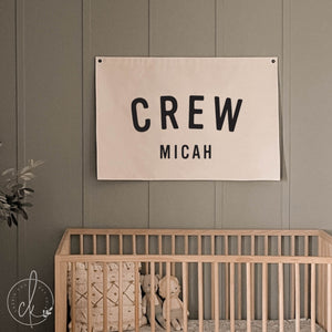 Nursery name sign canvas flag with personalized first and middle name in black block letters on cream canvas