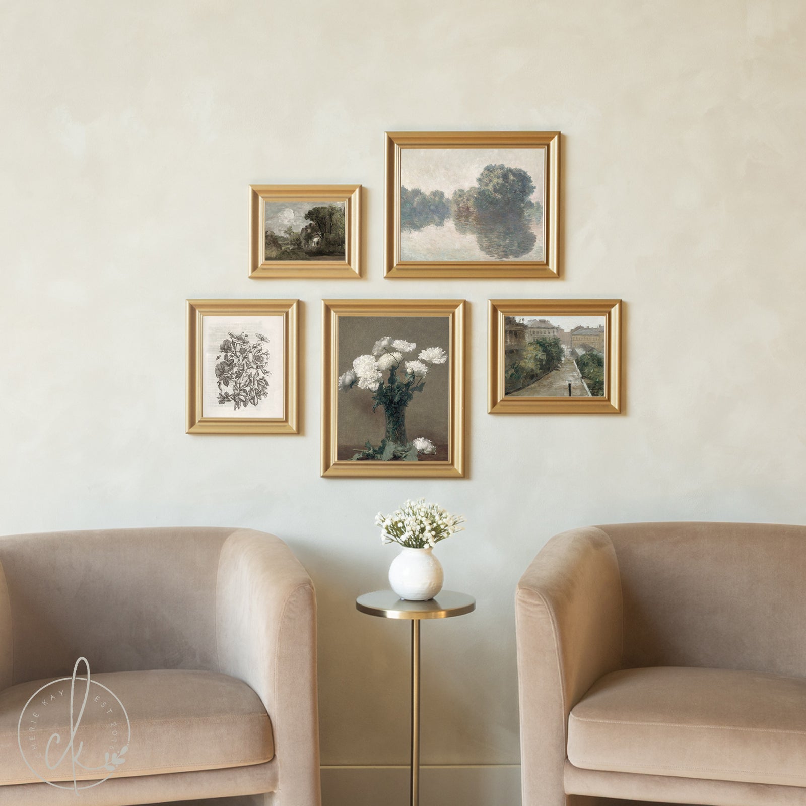 Five gold-framed artworks arranged in a sophisticated gallery wall above two blush velvet armchairs, showcasing a curated mix of landscapes, floral still lifes, botanical prints, and architectural scenes, centered around a prominent white carnation painting.