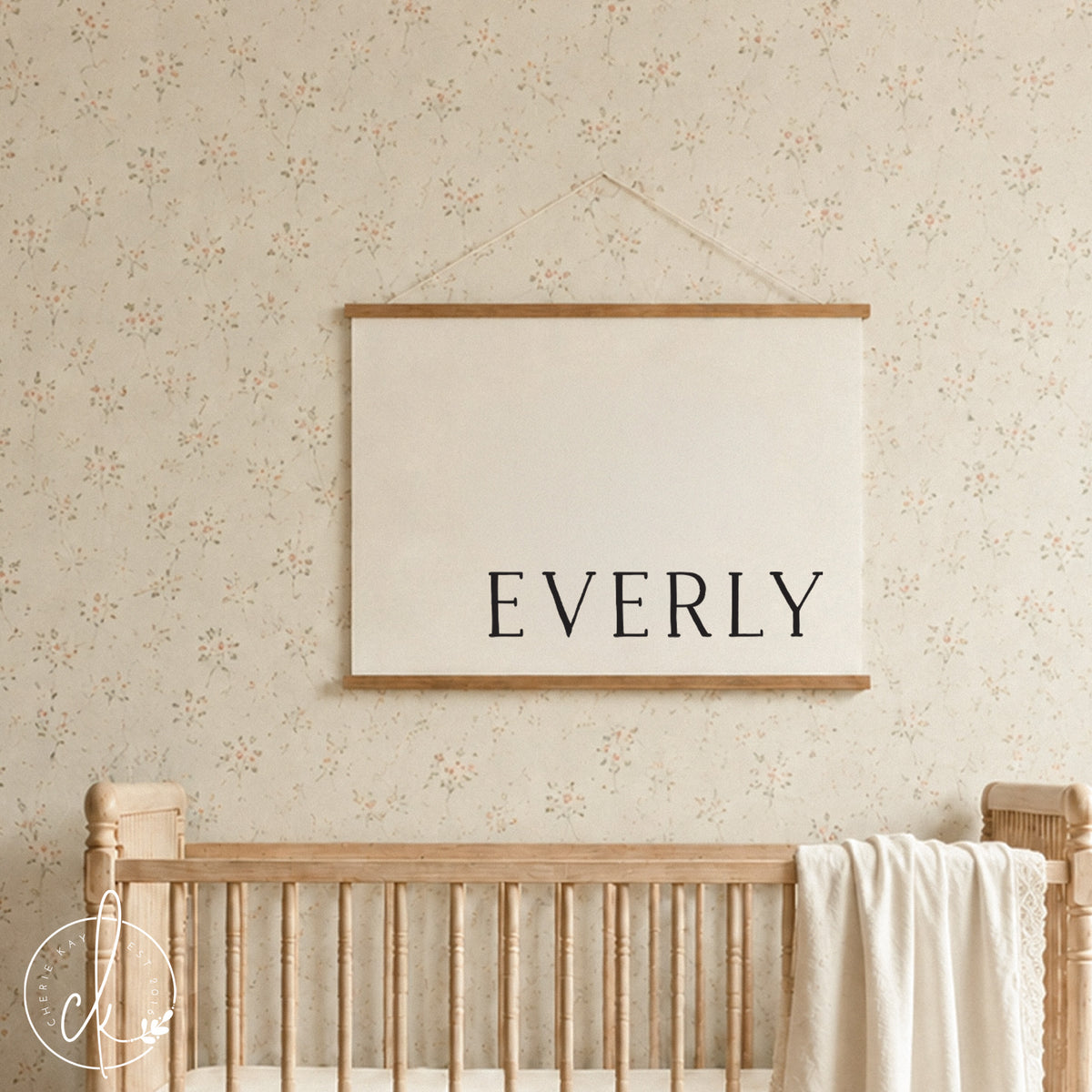 Custom nursery decor canvas banner with personalized baby name in serif lettering on cream canvas with wood strips