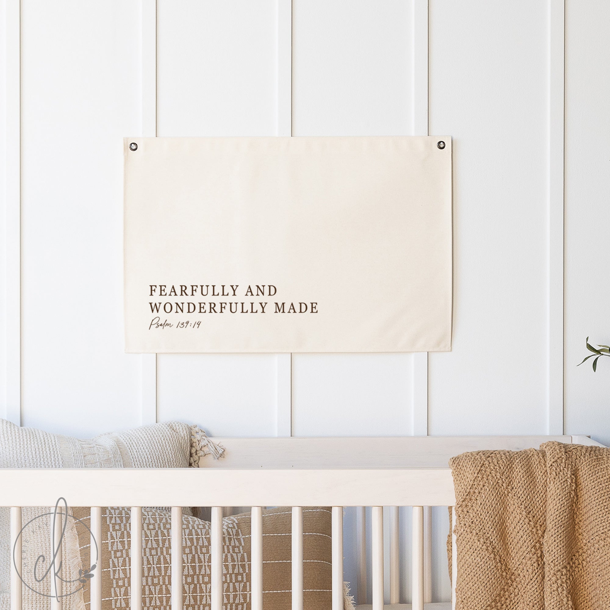 Nursery with a crib and a motivational poster on a white wall
