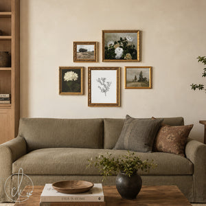 Five-piece vintage gallery wall set in ornate gold frames above a tan sofa, featuring botanical and floral prints with muted countryside scenes.