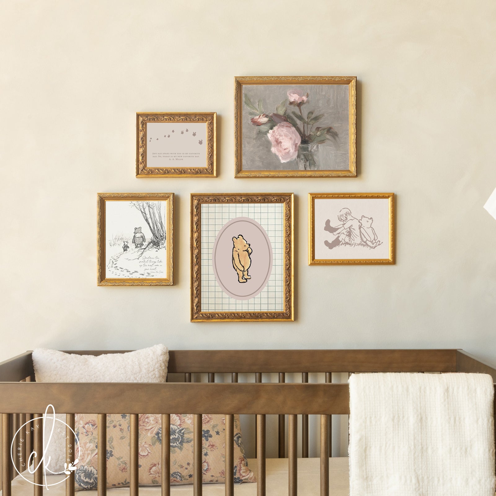 Winnie the Pooh nursery wall art with gold frames above baby crib in neutral nursery.