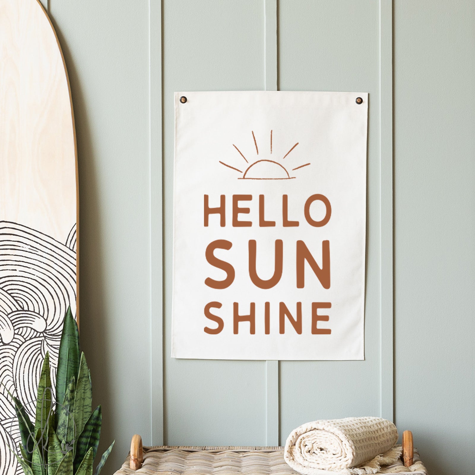 Decorative sign with 'Hello Sunshine' text on a light blue wall.