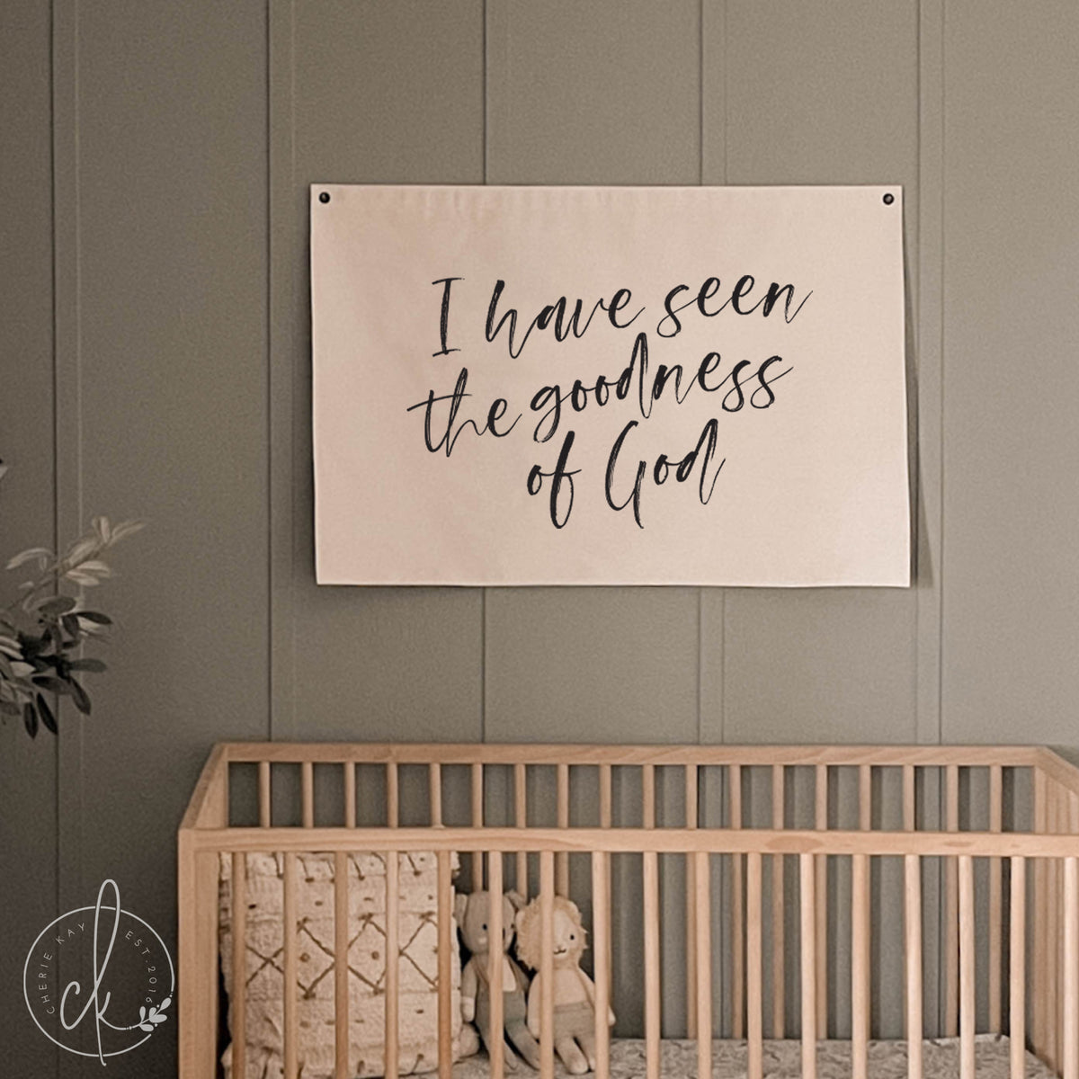 Nursery room with a crib and motivational poster on the wall.