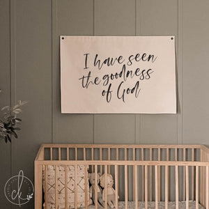 Nursery room with a crib and motivational poster on the wall.
