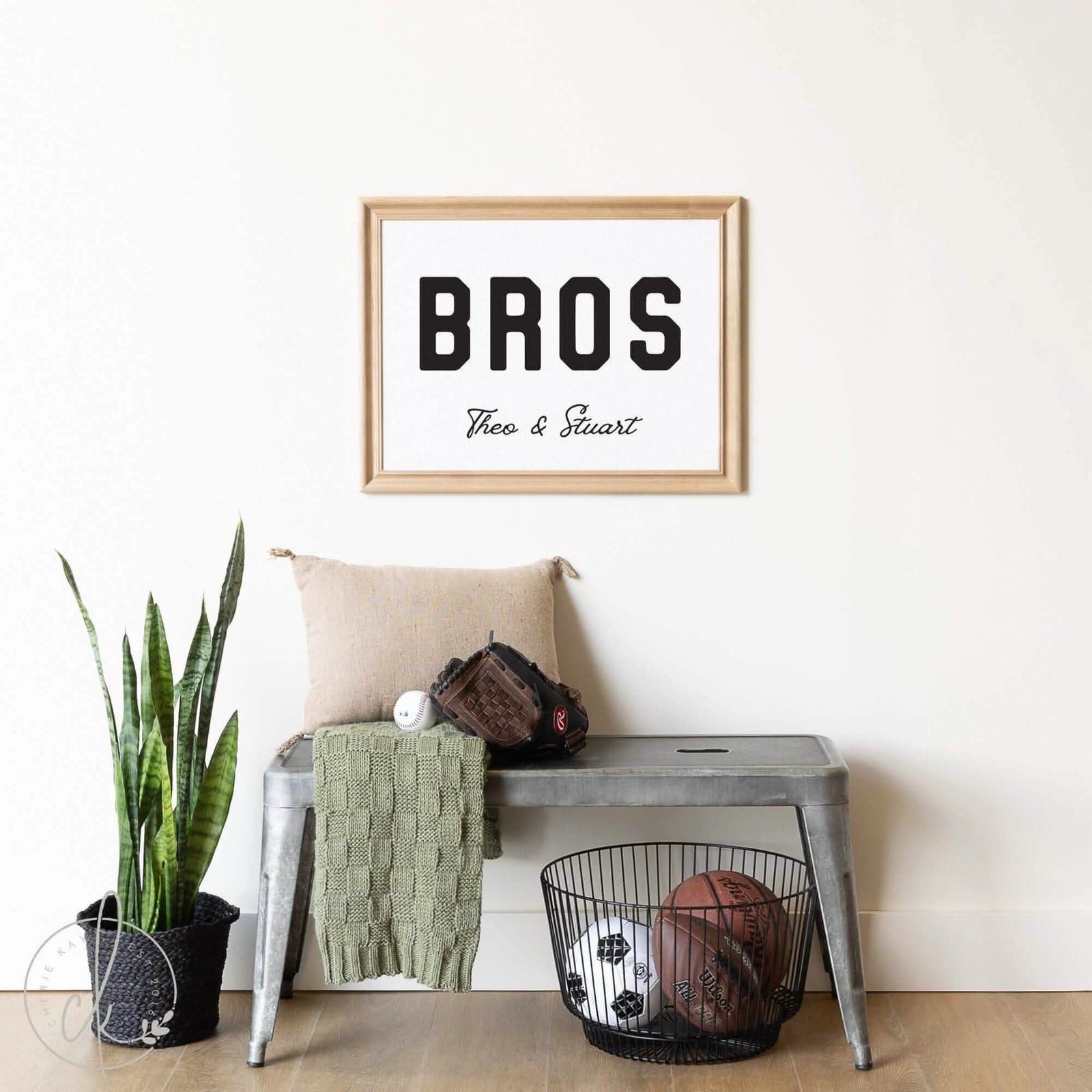 Personalized &quot;BROS&quot; sign for boys&#39; room decor, featuring customizable names, displayed in a modern nursery setting with a metal bench, plant, and sports equipment.