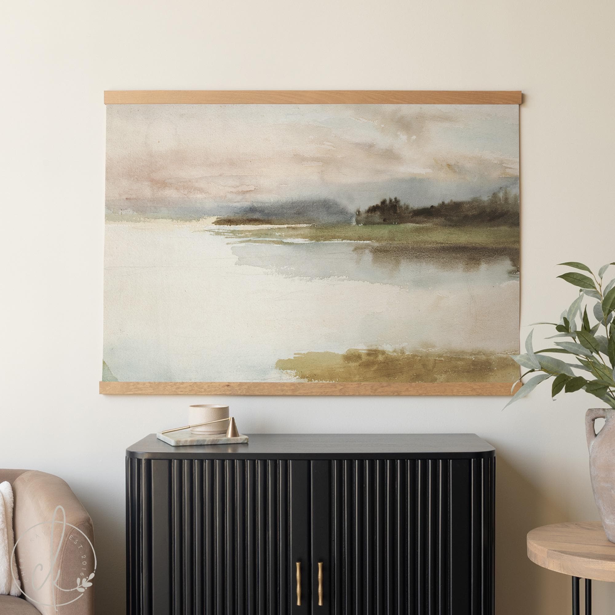 Extra-large watercolor landscape painting on a canvas tapestry—neutral lake scene on cotton canvas with soft greens and browns, styled above a sofa.