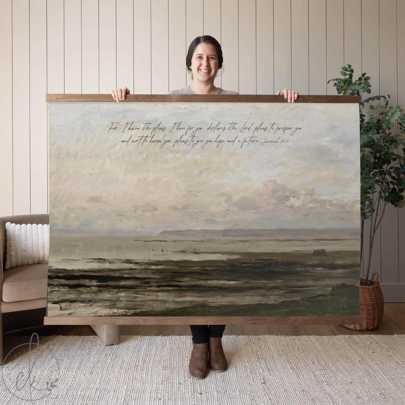 A large illustrated tapestry with a serene landscape scene, featuring rolling hills, soft earthy tones, and detailed artwork that resembles a peaceful countryside vista, hung on a wall for display.