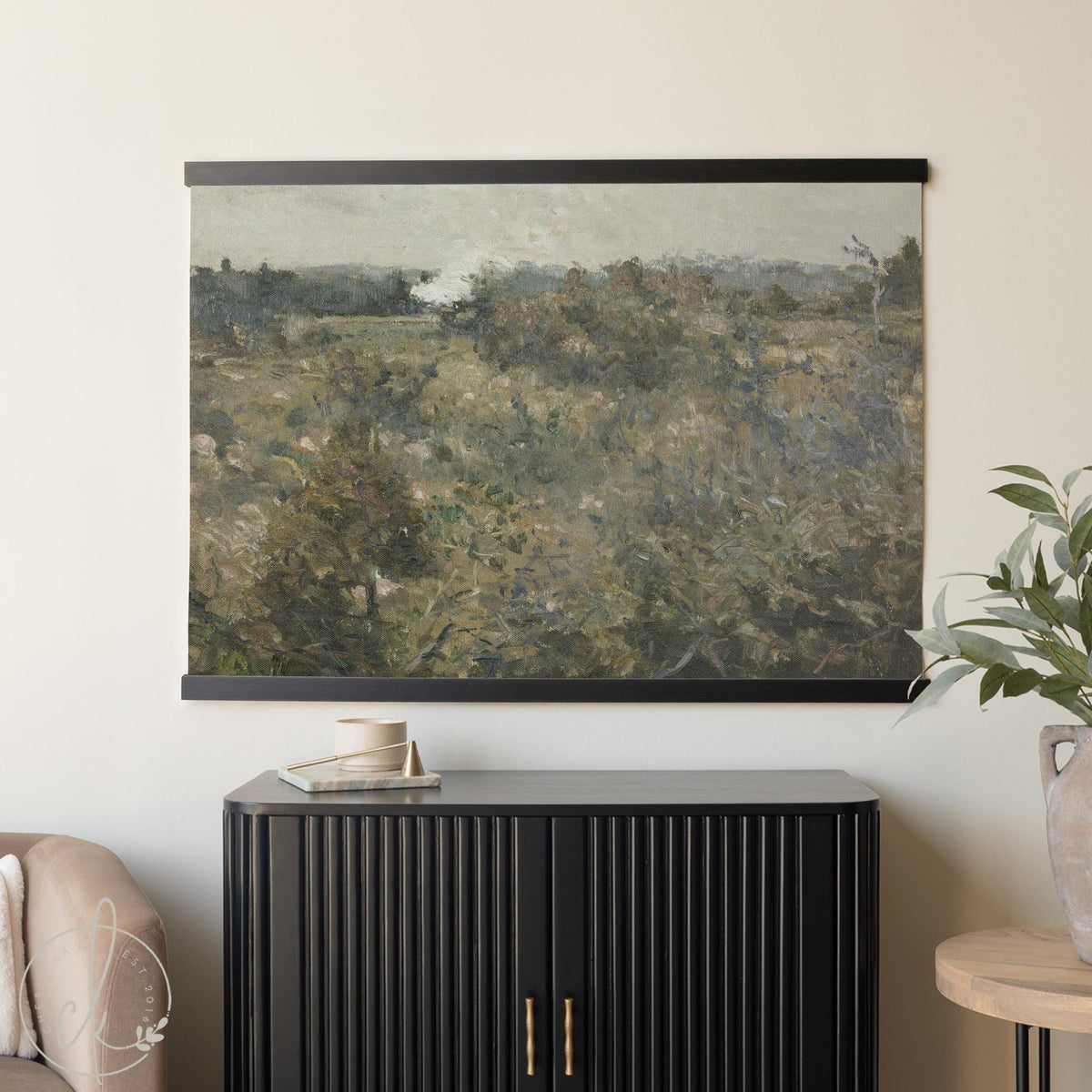 Large wall art tapestry featuring a vintage moody botanical field landscape, framed with handcrafted wood hangers.