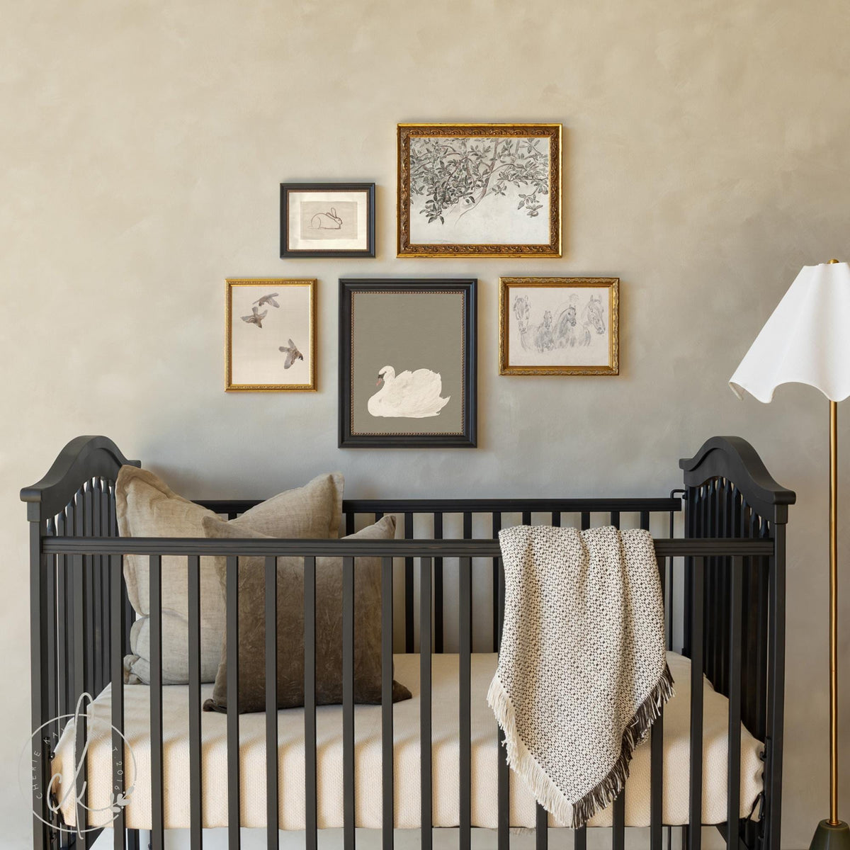 5-piece nursery wall art set of vintage animal &amp; botanical prints framed in ornate gold and black, styled above a crib.