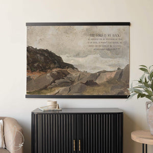 Vintage oil painting wall art featuring a rocky landscape and Psalm 18:2 scripture, styled as neutral Christian wall decor above a modern black console.
