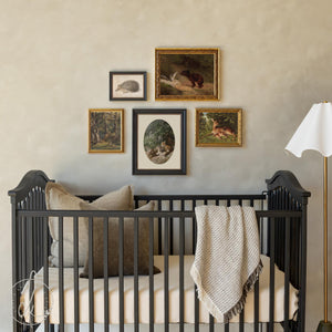 Woodland nursery wall art set of five vintage-style animal prints (fox, hedgehog, deer, squirrel, bear) in ornate gold and black frames.