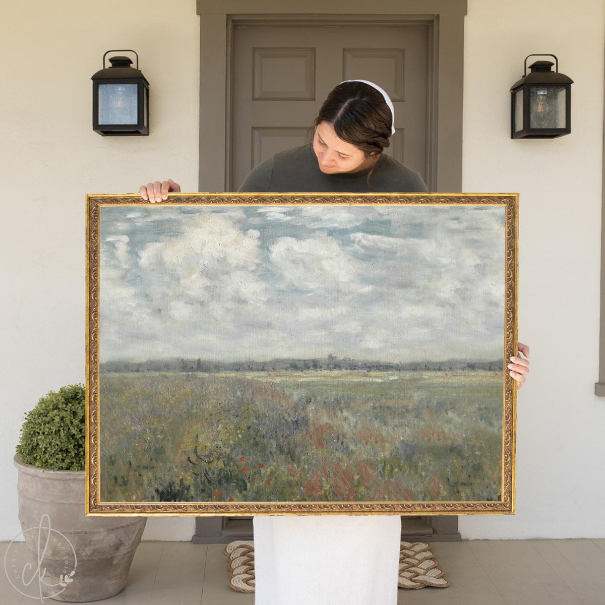 Framed wildflower field wall art featuring a soft cloudy sky and meadow landscape.