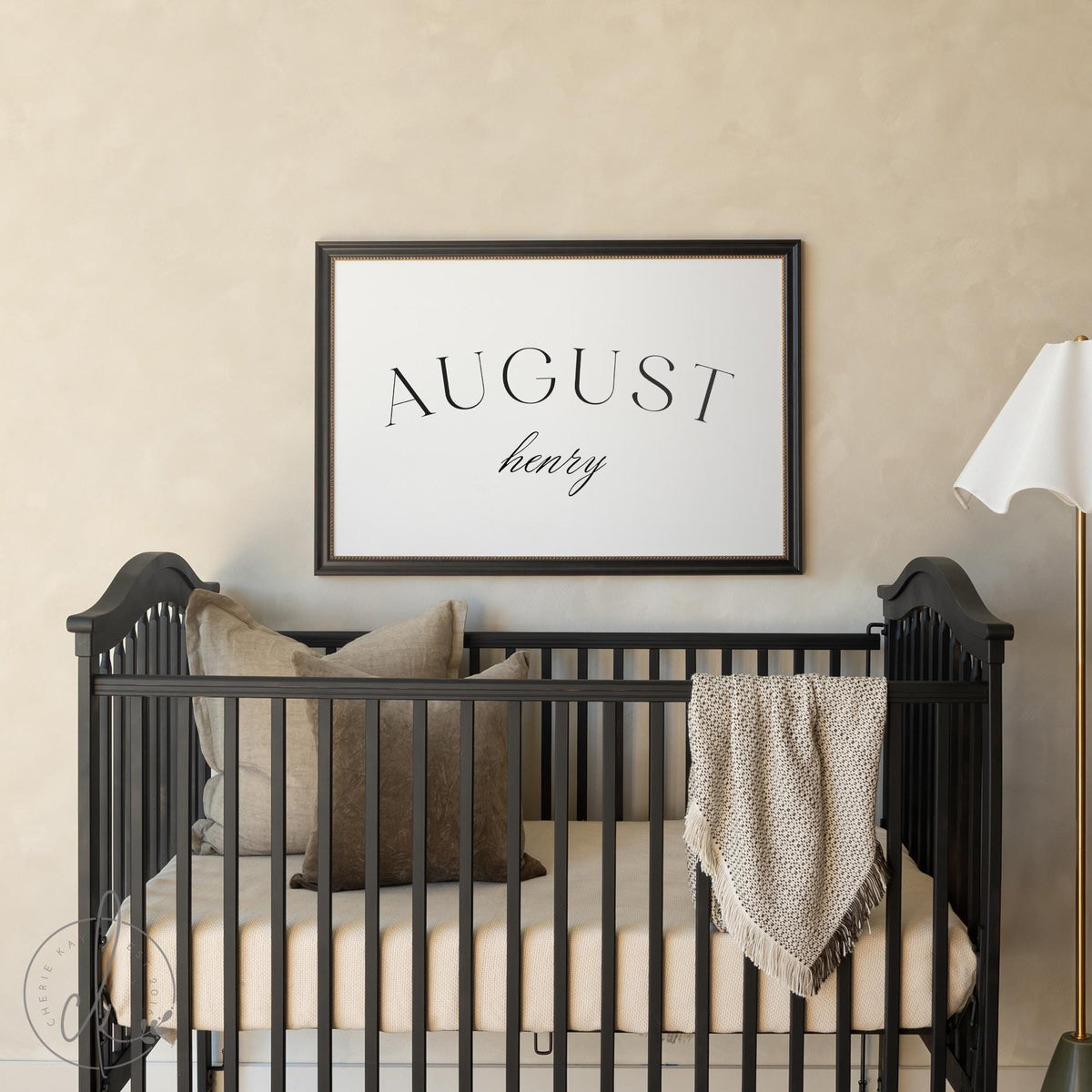 Personalized name sign for nursery with ornate gold frame and custom baby name printed on canvas in neutral tones.