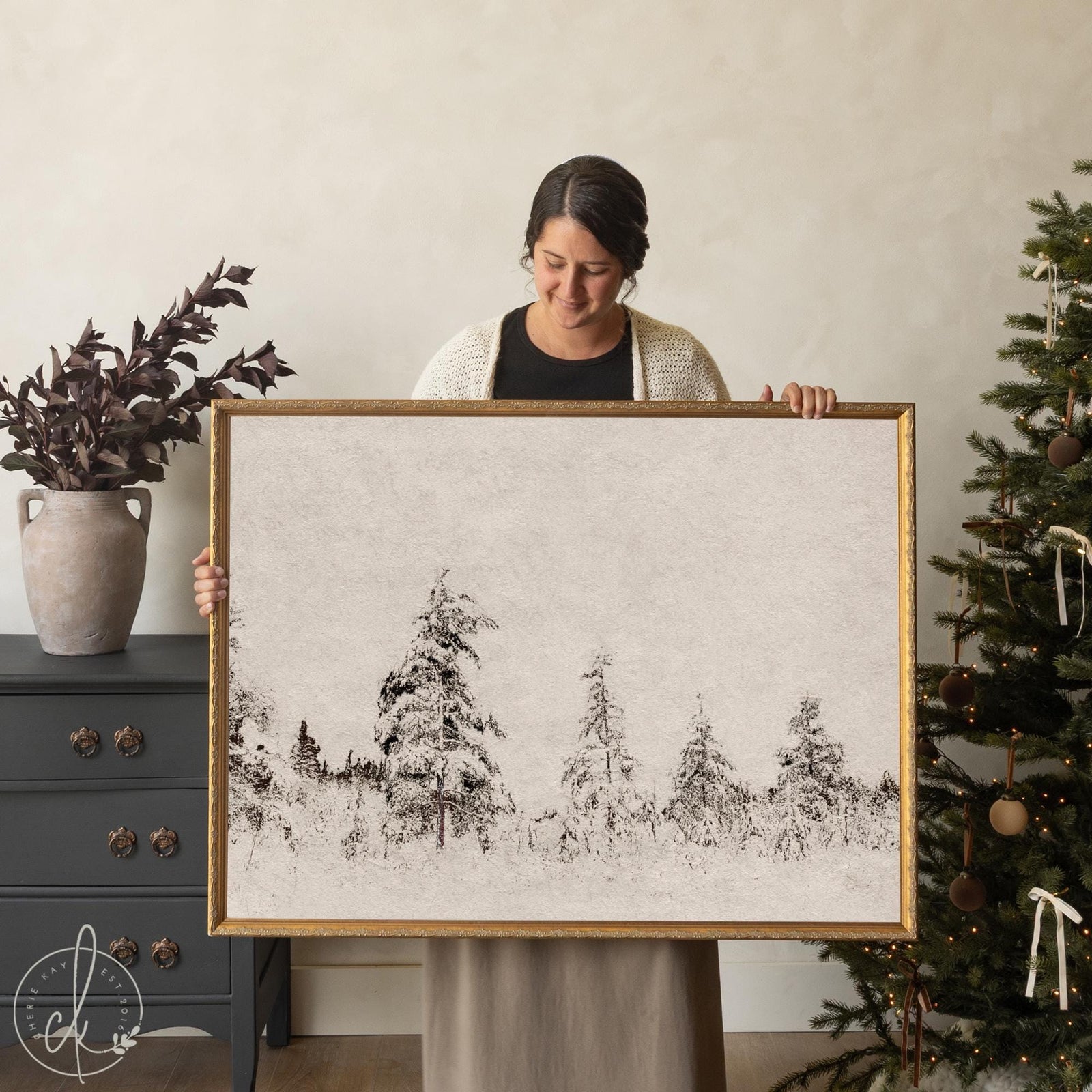 Framed winter wall art with snowy forest scene in gold frame, ideal for Christmas home decor.