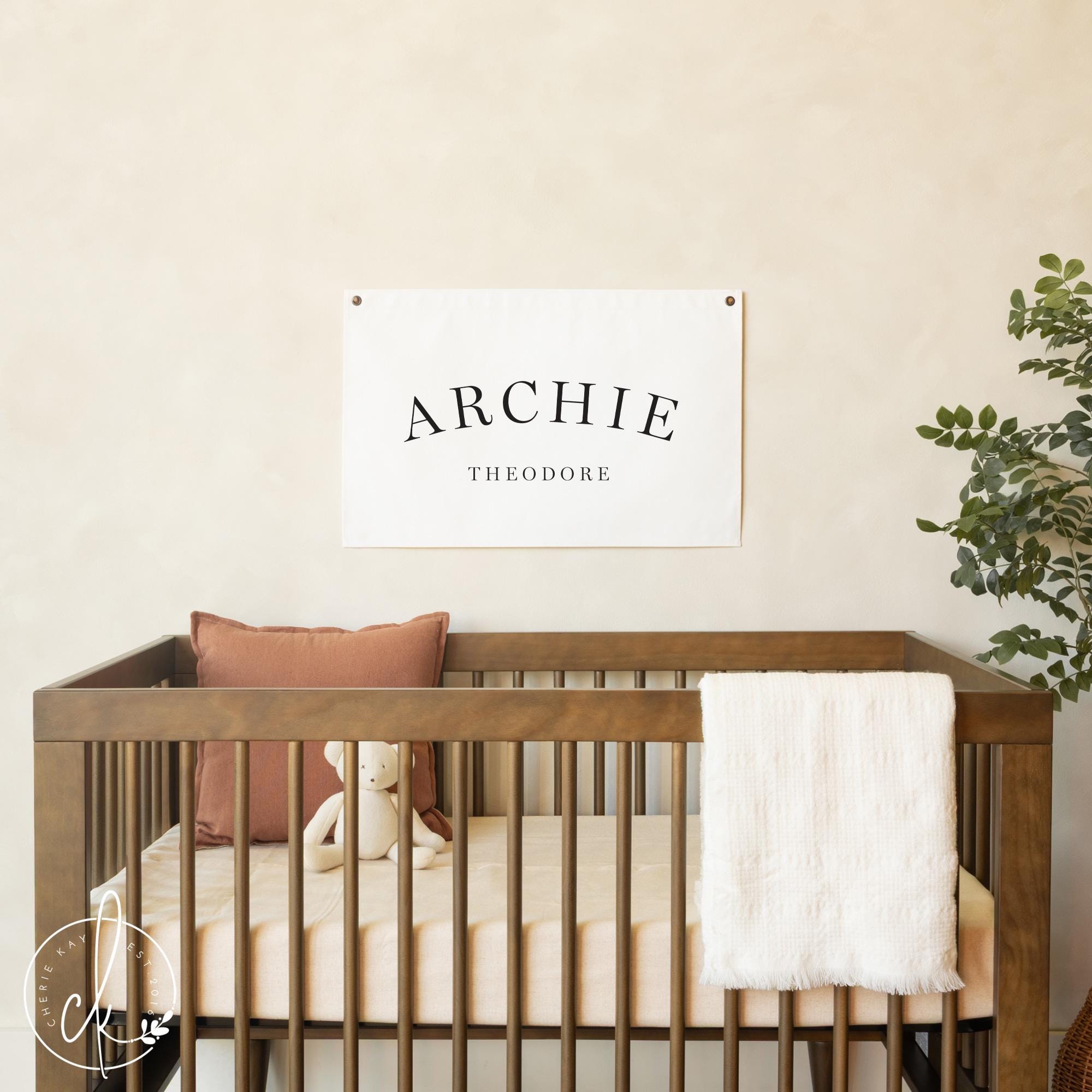 Personalized fabric nursery wall art featuring baby name flag for neutral nursery decor.