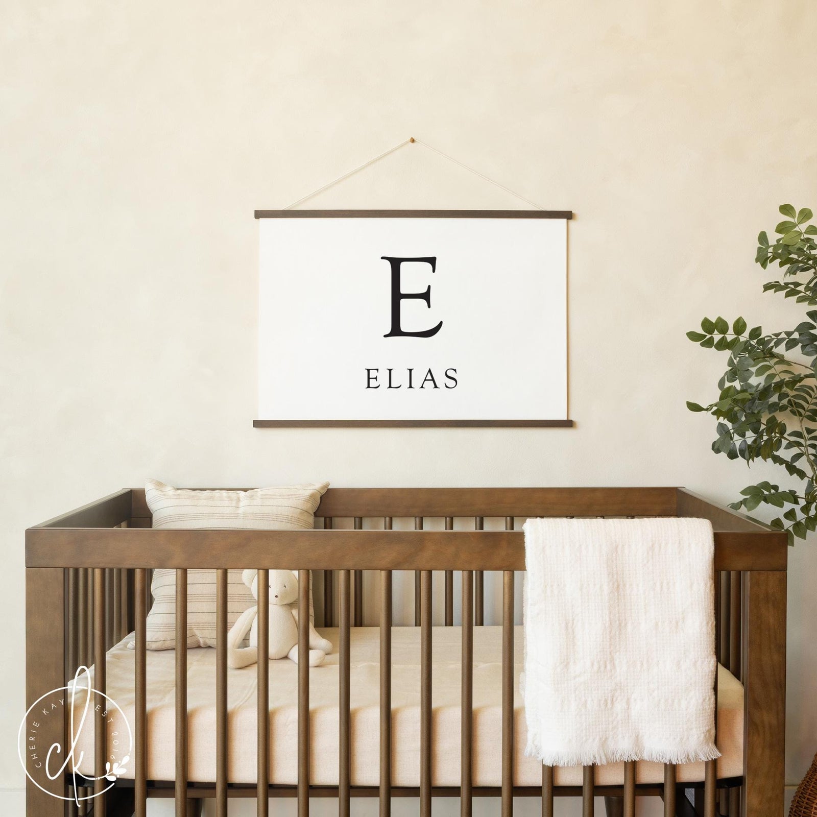 Personalized nursery name sign with child’s initial and name in neutral modern design.
