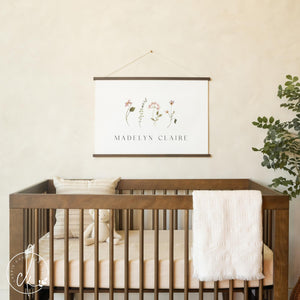 Floral nursery decor with personalized baby name and botanical flower illustrations