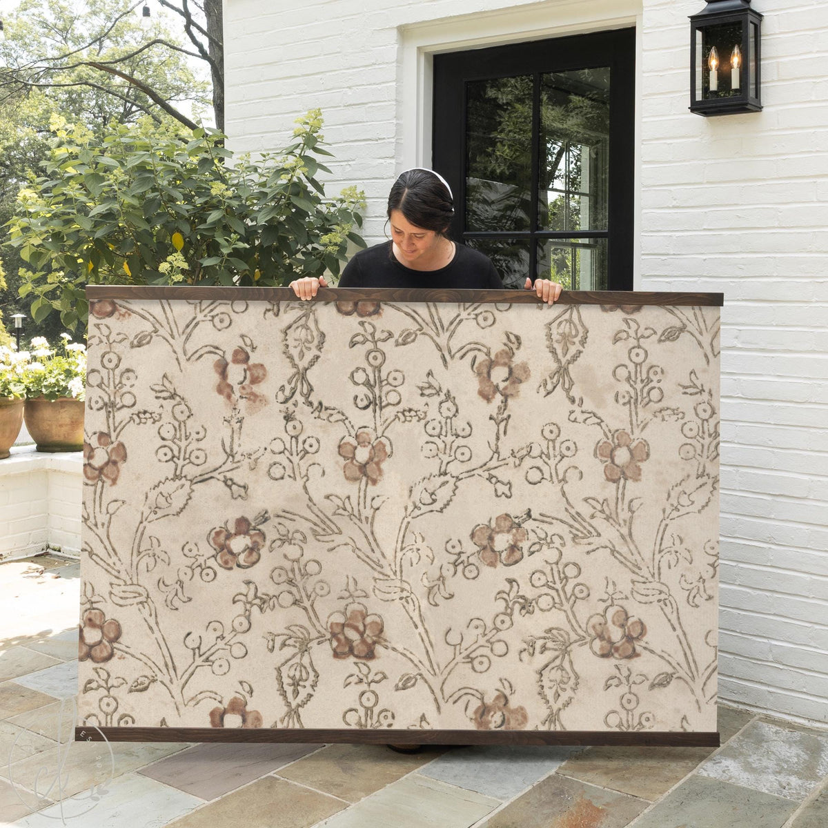 Neutral floral textile wall art with wooden hangers, botanical fabric wall decor.