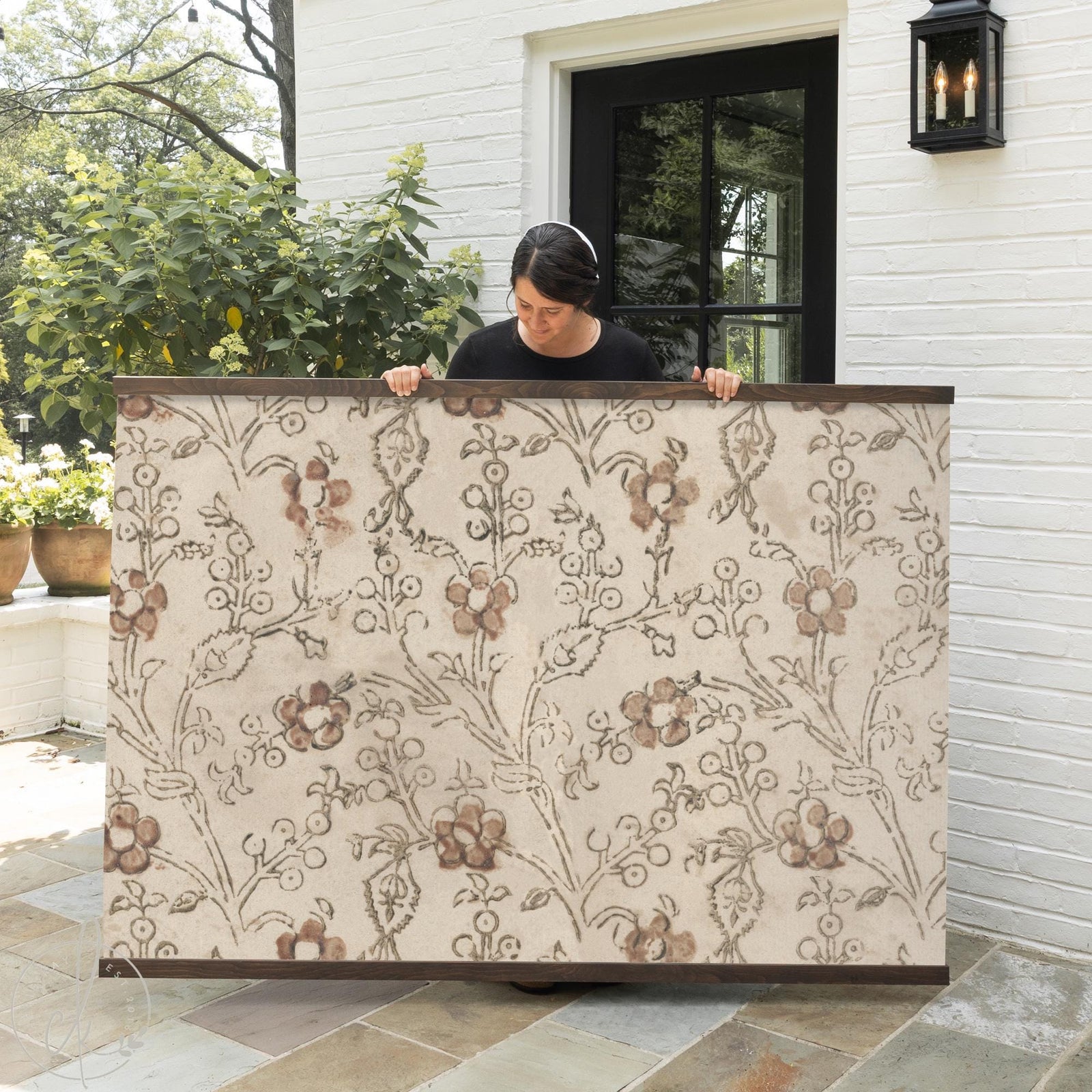 Neutral floral textile wall art with wooden hangers, botanical fabric wall decor.