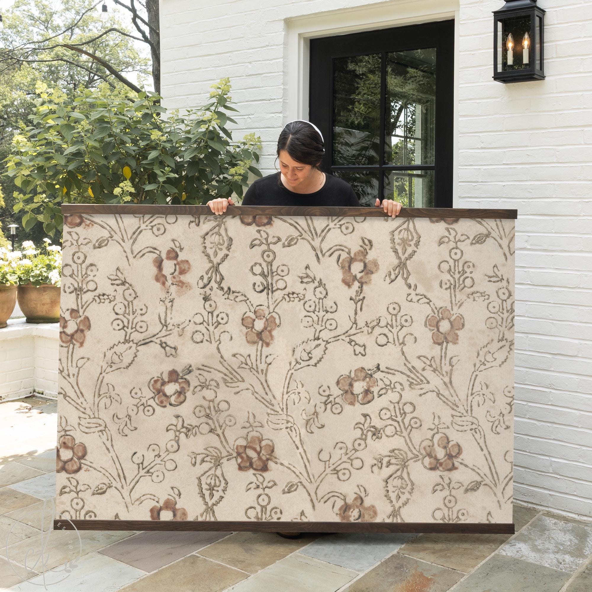 Neutral floral textile wall art with wooden hangers, botanical fabric wall decor.