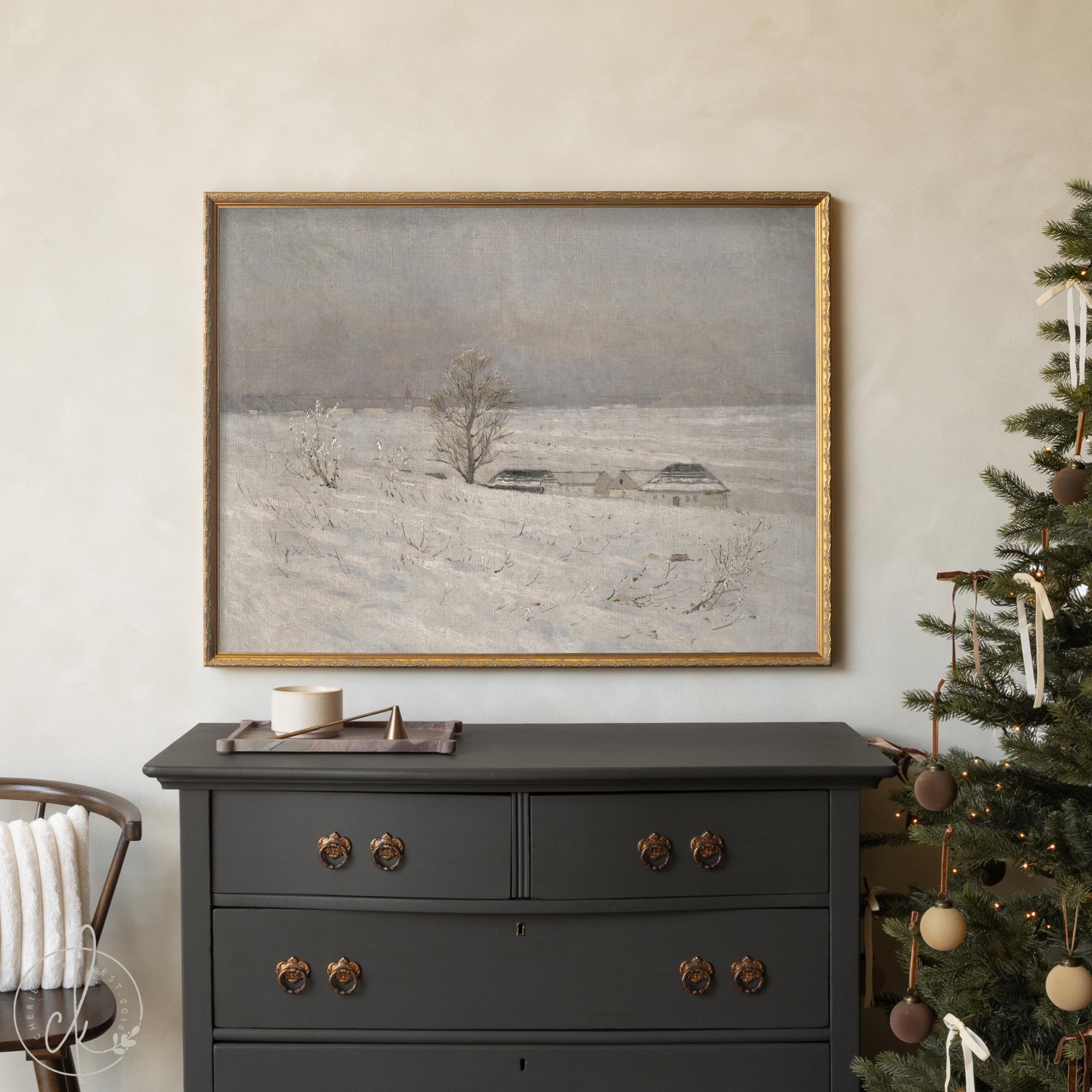 Framed snowy landscape painting with farmhouse in winter field — neutral wall art for living room or Christmas decor.