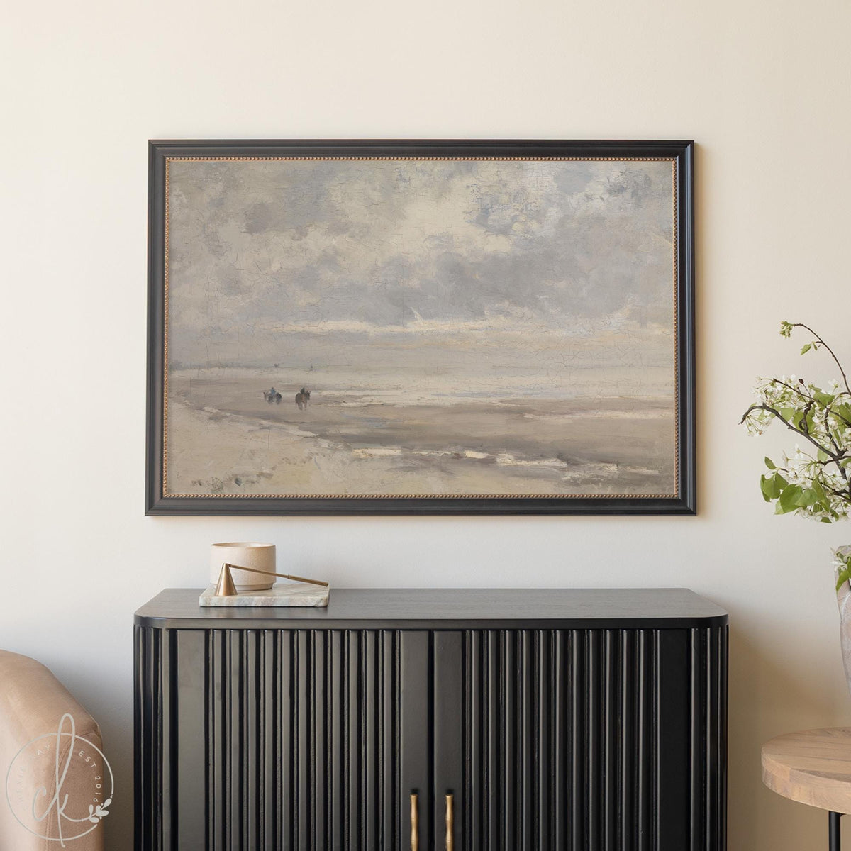 Framed vintage coastal art with beach landscape and muted ocean tones.