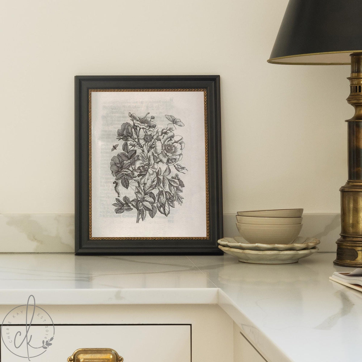 Framed vintage flower print with black and white botanical illustration and leaves.