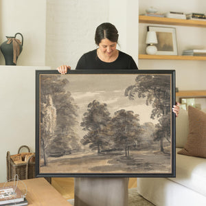 Moody landscape wall art in a black frame with gold beaded liner, a charcoal woodland tree scene.