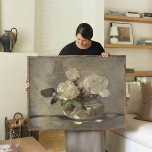 Framed canvas white flower wall art featuring white blooms in a glass vase on a neutral background.