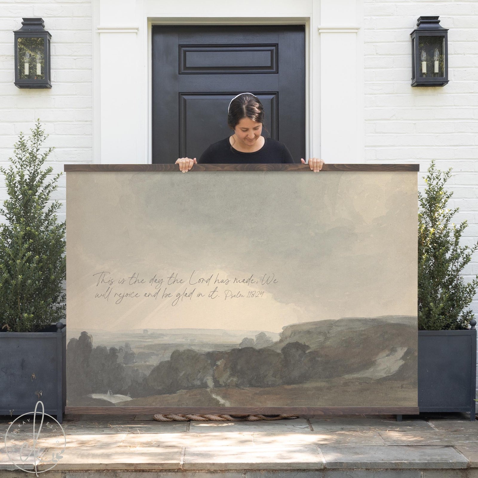 Christian tapestry with Psalm 118:24 verse over a soft countryside landscape canvas.