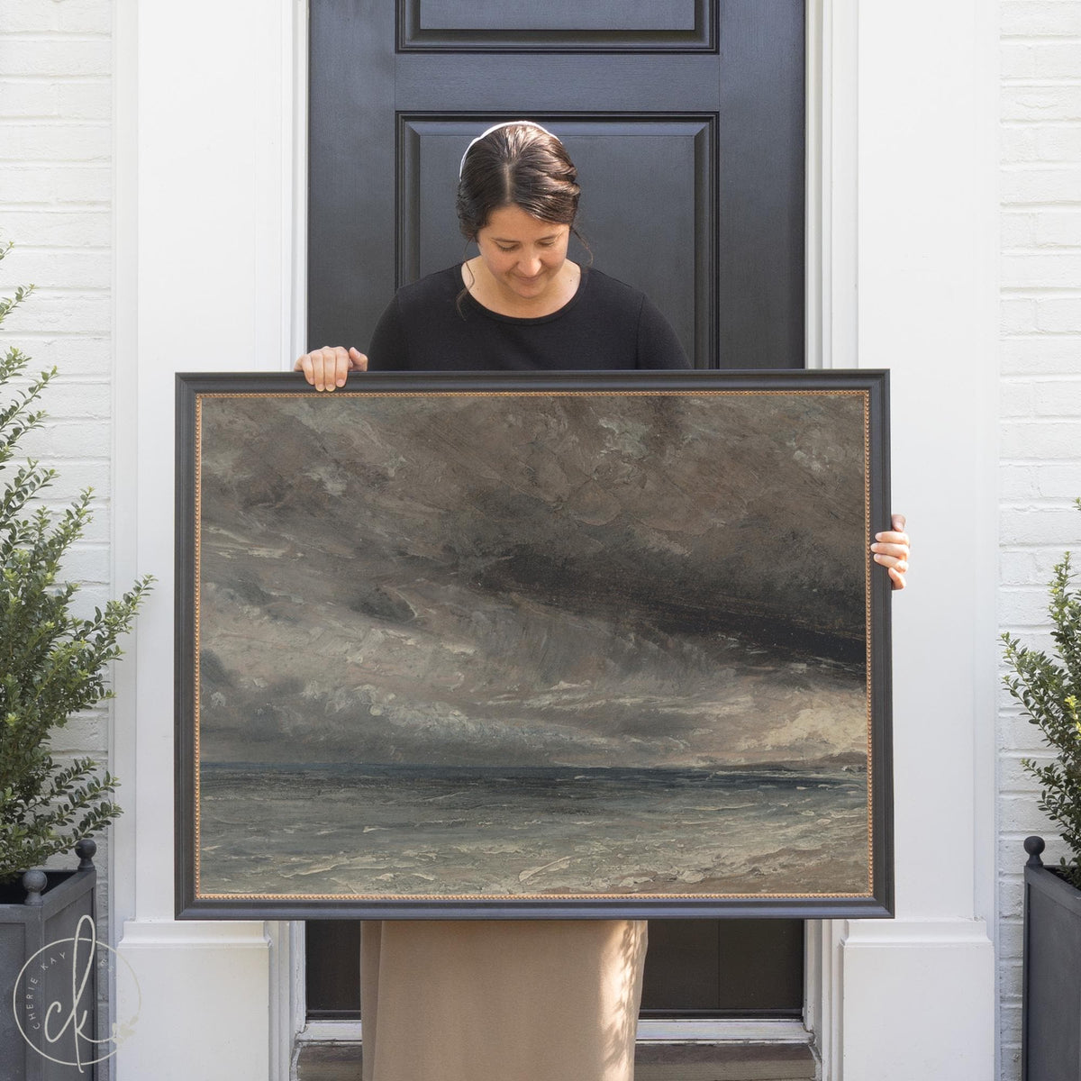 Framed stormy ocean painting with dark clouds and waves — large coastal wall art for living room.