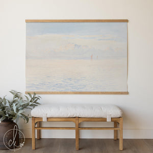Large coastal wall art canvas tapestry with sailboat and calm ocean view in soft blue tones