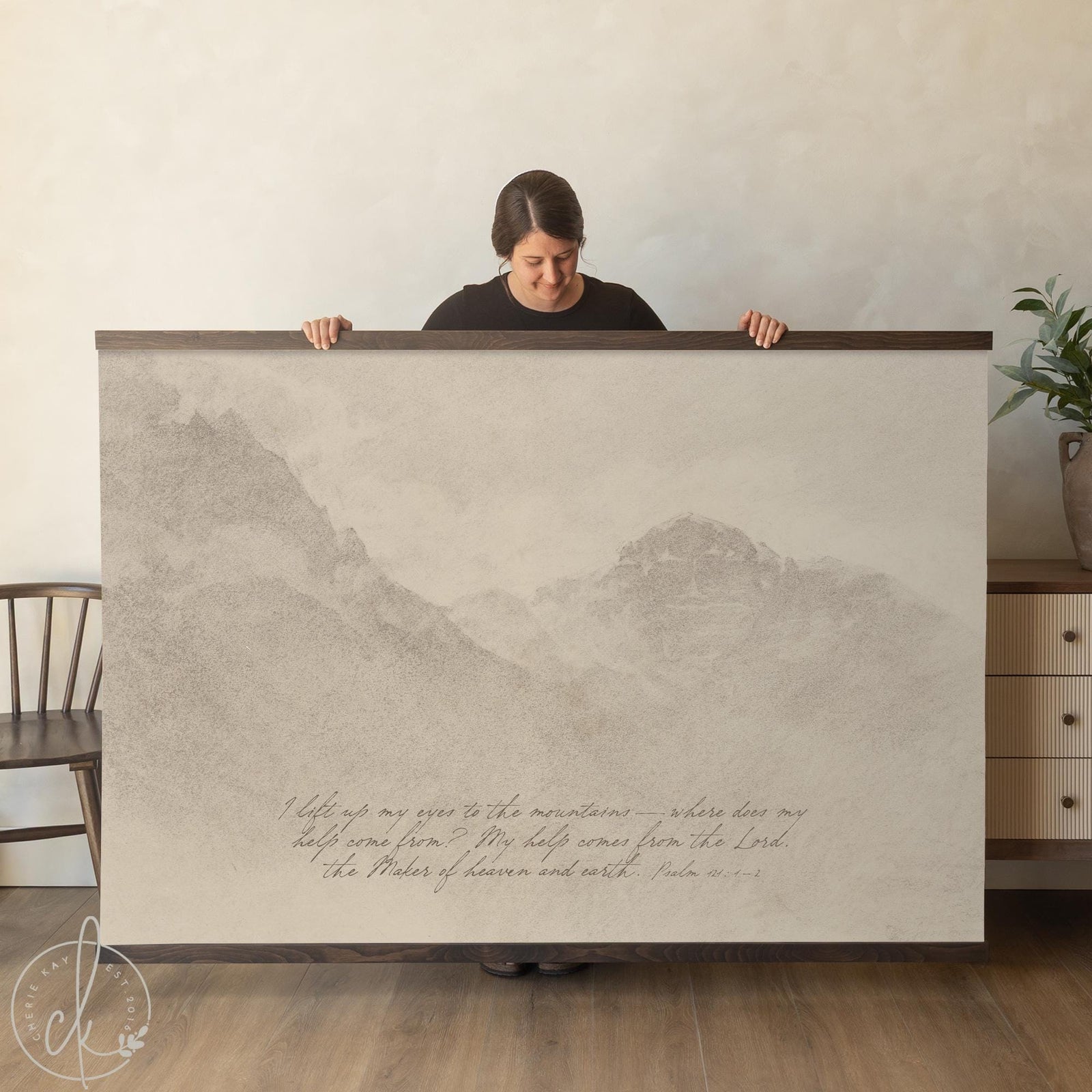 Large Christian canvas wall art tapestry with Psalm 121 mountain landscape in neutral tones hanging from natural wood frame