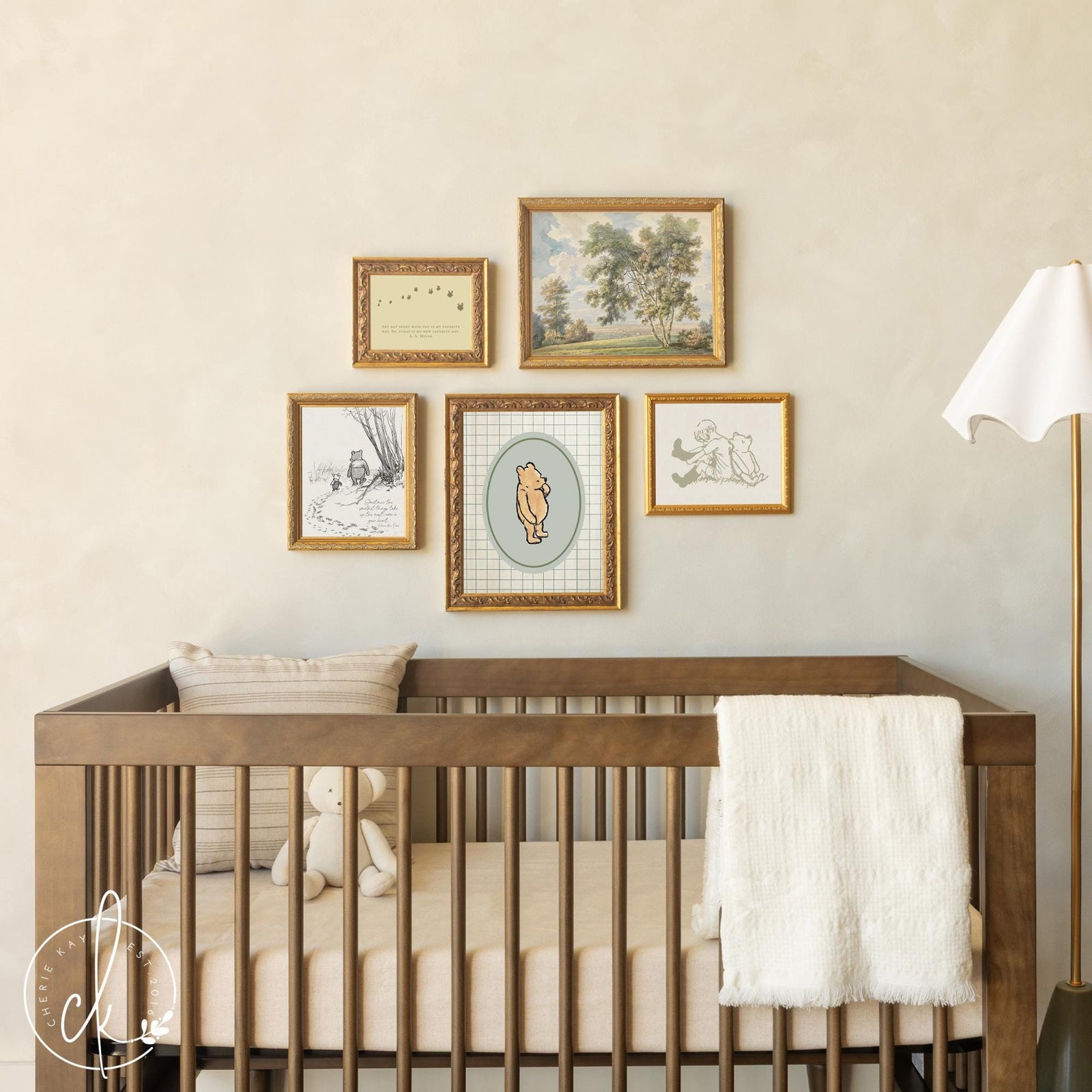 Winnie the Pooh wall decor vintage nursery gallery wall with framed canvas prints above crib.